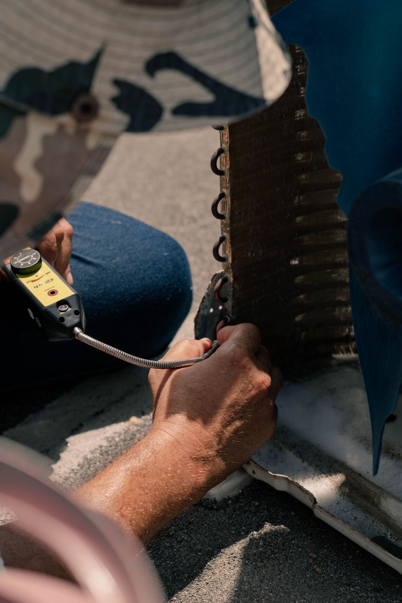 Close-up of a technician's hands working on furnace components
