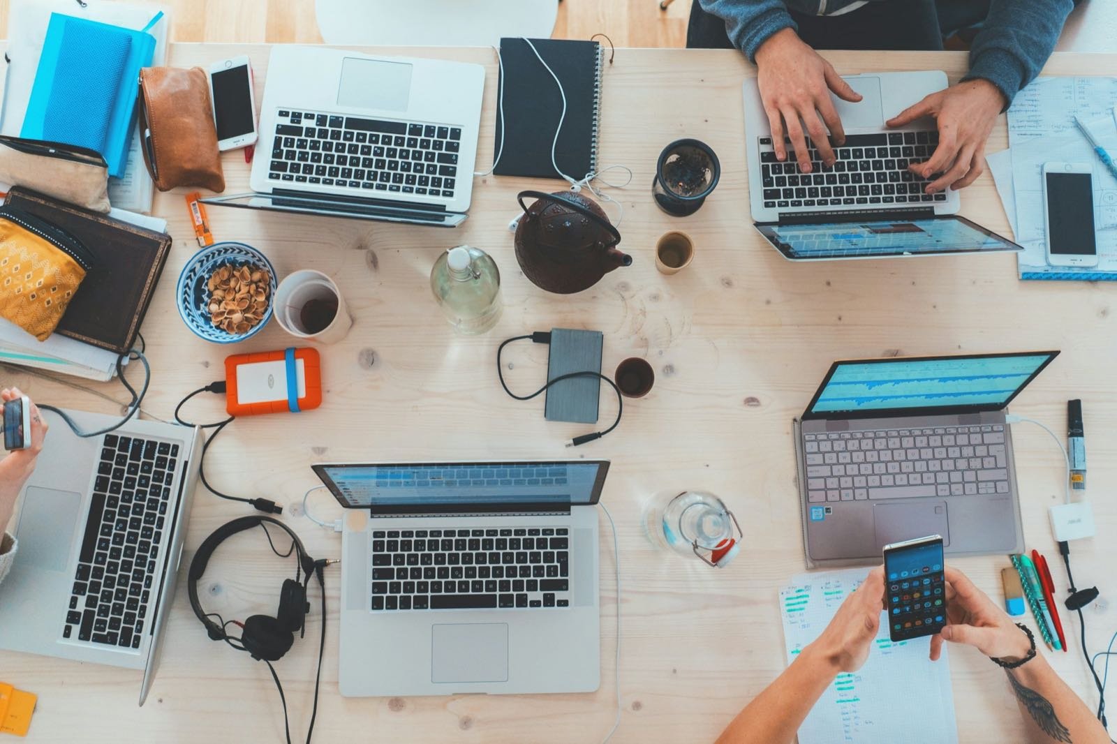 A team's shared desk with laptops and notes